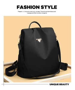 Detail view of water-resistant black nylon backpack with metal POA BA brand logo