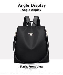 Detailed front view of black waterproof nylon backpack with gold-tone metal zippers