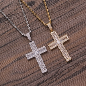 Detailed view of gold and silver hip hop cross pendants with baguette-cut cubic zirconia