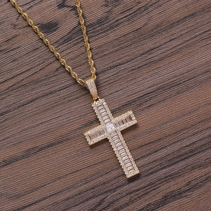Hip hop gold cross pendant necklace with cubic zirconia on a rustic dark wood background