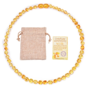 Natural Baltic amber baby necklace with linen pouch and certificate on white background