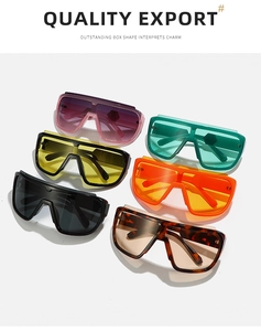 Multiple colorful oversized square sports sunglasses displayed on white platforms
