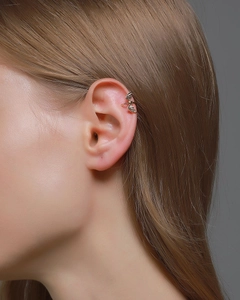 Macro shot of a vintage gold bat wing ear cuff on a model's ear for Gothic style