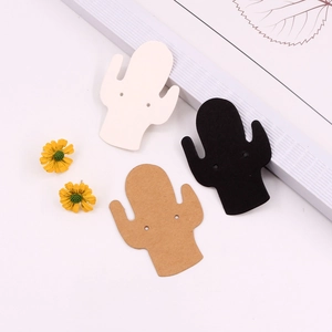 Three cactus-shaped earring display cards in black, white, and brown paper materials