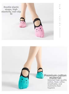 Close-up of pink and blue yoga socks with cat pattern and double elastic straps