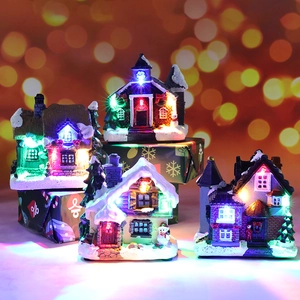 LED lighted Christmas resin house set with snow detail and festive bokeh background