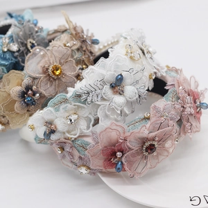 Detailed macro view of baroque sponge headband featuring lace petals and crystal beads