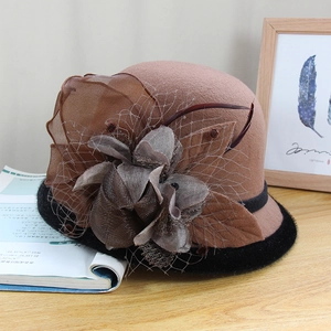 Elegant wool felt cloche hat in camel with black faux fur trim and floral feather accents