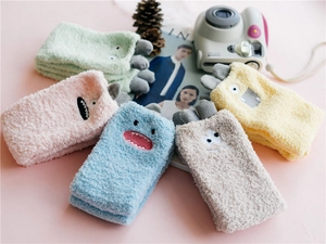 Flat lay of colorful plush monster coral fleece socks in five vibrant colors