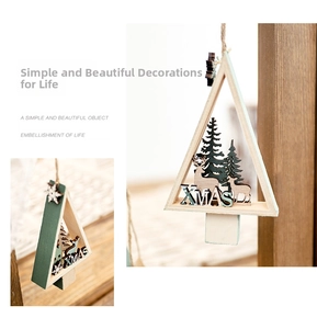 Detail of wooden Christmas tree ornament with carved elk and XMAS hollowed-out design
