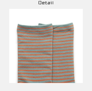 Detail shot of the fine blue and orange striped knit cotton texture on women socks