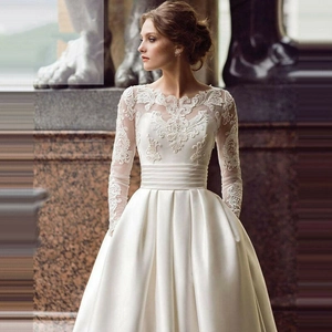 Elegant white long sleeve wedding dress with lace bodice and satin train for women