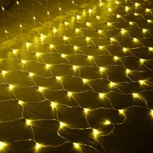 Detail of warm yellow LED net lights showing glowing beads on dark textured tiles