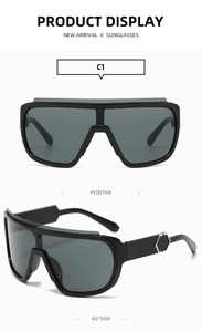 Detail view of large-frame cycling sunglasses with silver hexagonal metal accents on temples