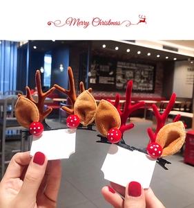 Detail showing a pair of plush reindeer antler hair clips with red polka dot decor