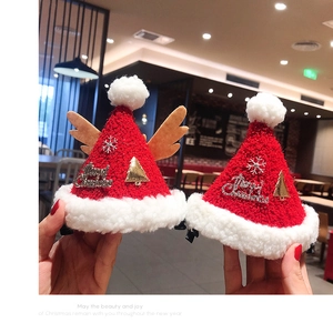 Close-up of mini knitted Christmas hat hair clips with Merry Christmas metal charms