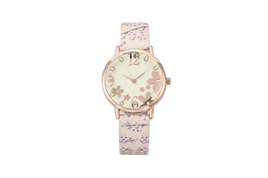 Macro detail of rose gold watch face with floral patterns and pink cherry blossom strap