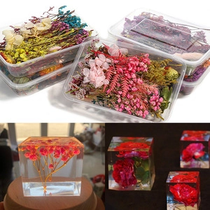 DIY cube resin mold craft with dried flower inclusions in multiple vibrant colors