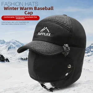 Close-up of winter trapper hat with protective face mask and thick ear flaps over snow mountains