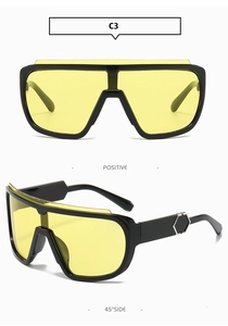 Detail of oversized sports sunglasses with yellow lenses and silver hexagonal side accents