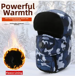 Detail of blue camouflage trapper hat featuring warm fleece lining and black breathing valve