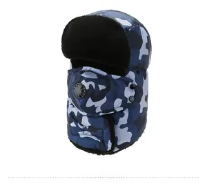 Detail view of blue camo trapper hat featuring a breathable valve mask and faux fur lining