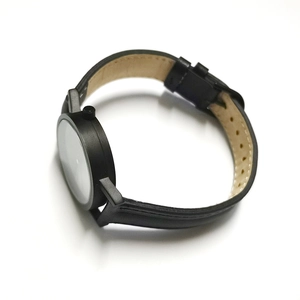 Side view detail of a minimalist waterproof leather watch with a black polished case