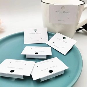 White earring display cards with 925 silver post marking on a blue jewelry tray