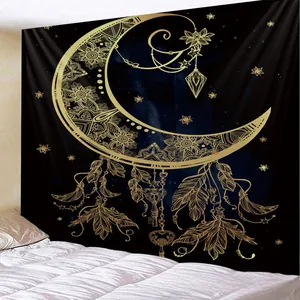 Detail of bohemian mandala tapestry featuring golden moon and stars on black fabric