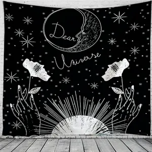 Detail of black and white sun and moon tapestry with Dear Universe text on white wall