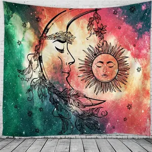Detail of bohemian tapestry featuring sun, moon, and nebula patterns on white brick wall