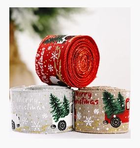 Close-up of Christmas ribbons with red truck and snowflake patterns for tree decoration