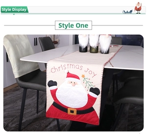 Detail of Christmas table runner with embroidered Santa Claus and Christmas Joy text
