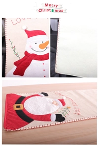 Detail of Christmas table runner showing Santa Claus embroidery and LOVE text on fabric