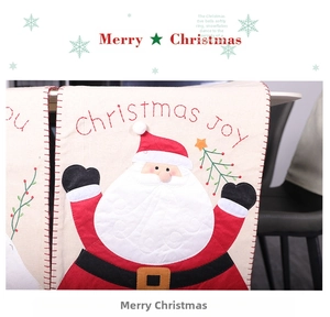 Detail of Christmas Santa embroidery and 'JOY' text on cream table runner fabric