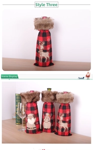 Detail of red and black plaid wine bottle covers with fur trim and festive embroidery