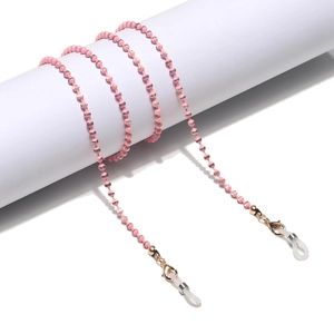 Detailed view of pink beaded sunglasses strap with gold lobster clasps and silicone loops