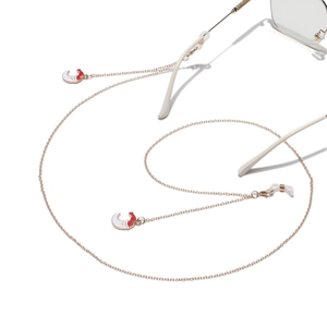 Detail of rose gold non-slip eyewear chain featuring moon pendant and silicone loops