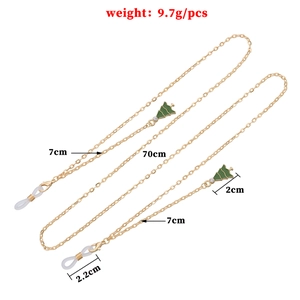 Golden metal eyewear chain featuring green enamel Christmas tree tassels and lobster clasps