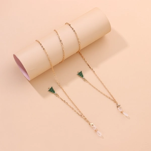 Detail of golden glasses chain with green enamel Christmas tree charms on display