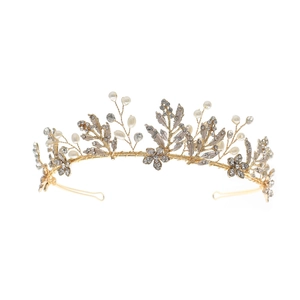 Close-up of luxury bridal headband with golden wire, clear crystals and white pearls