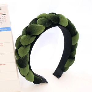 Detailed view of dark green braided velvet headband with thick padded texture and non-slip lining