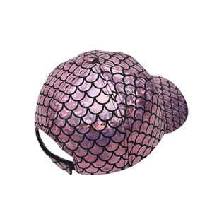 Macro detail of holographic pink mermaid scale texture on a trendy baseball cap