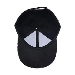 Detail showing the inner structure of a black snake pattern baseball cap with a white support lining