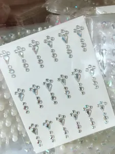 Macro shot of self-adhesive teardrop and round rhinestones for eye makeup and DIY art