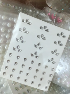 Macro shot of assorted teardrop rhinestones on card for facial makeup and nail art DIY