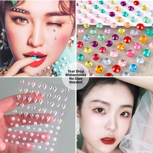 Macro shot of self-adhesive tear-shaped rhinestones and pearls for creative eye makeup