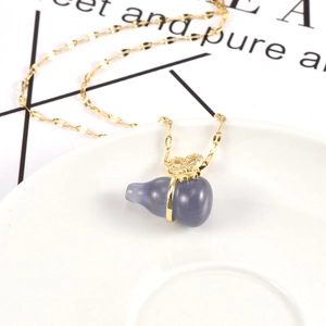 Golden opal gourd necklace with blue cat eye stone pendant and crystal bow tie