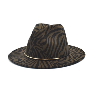 Close-up of zebra pattern wool fedora hat featuring a stylish gold metal band decoration