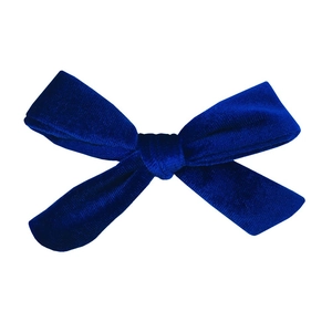 Detailed view of handmade dark blue velvet bow showing rich texture and soft fabric sheen